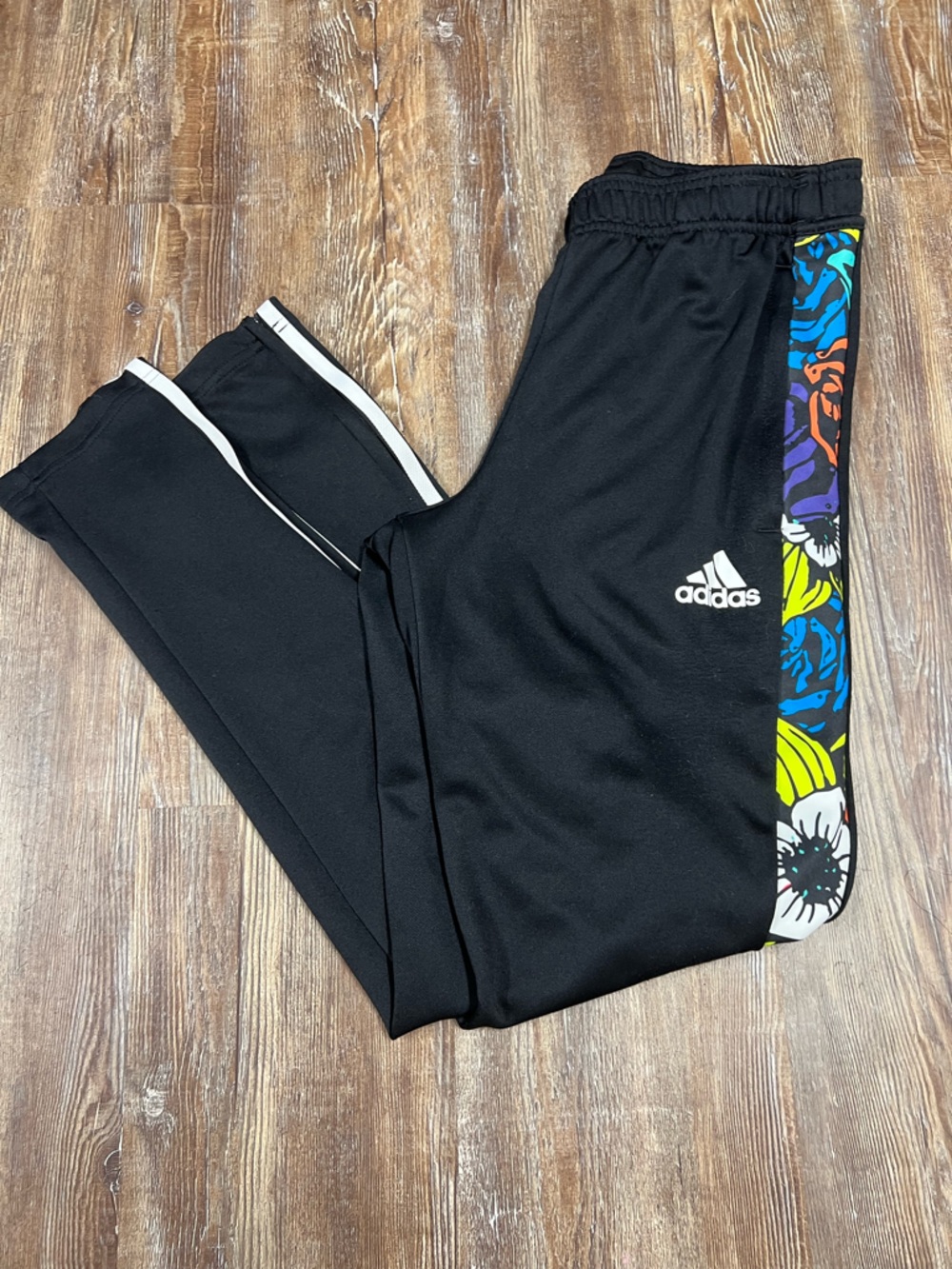 Adidas black track pants with colorful graphic design